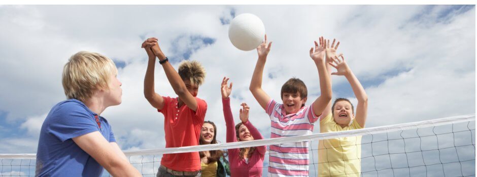 teenagers playing volleyball